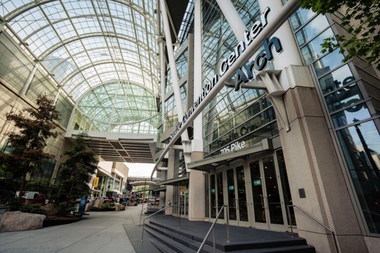Large glass and steel building with glass arch